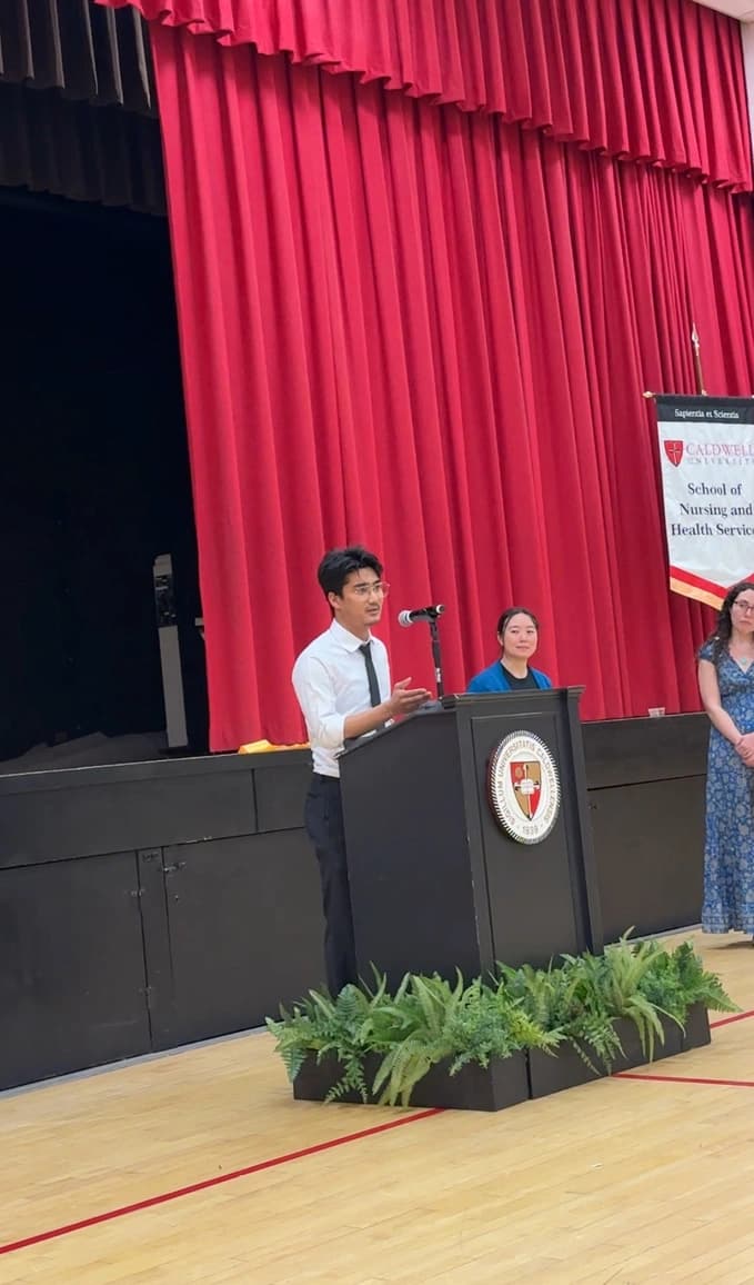 Speaking at a podium at a Caldwell University event.