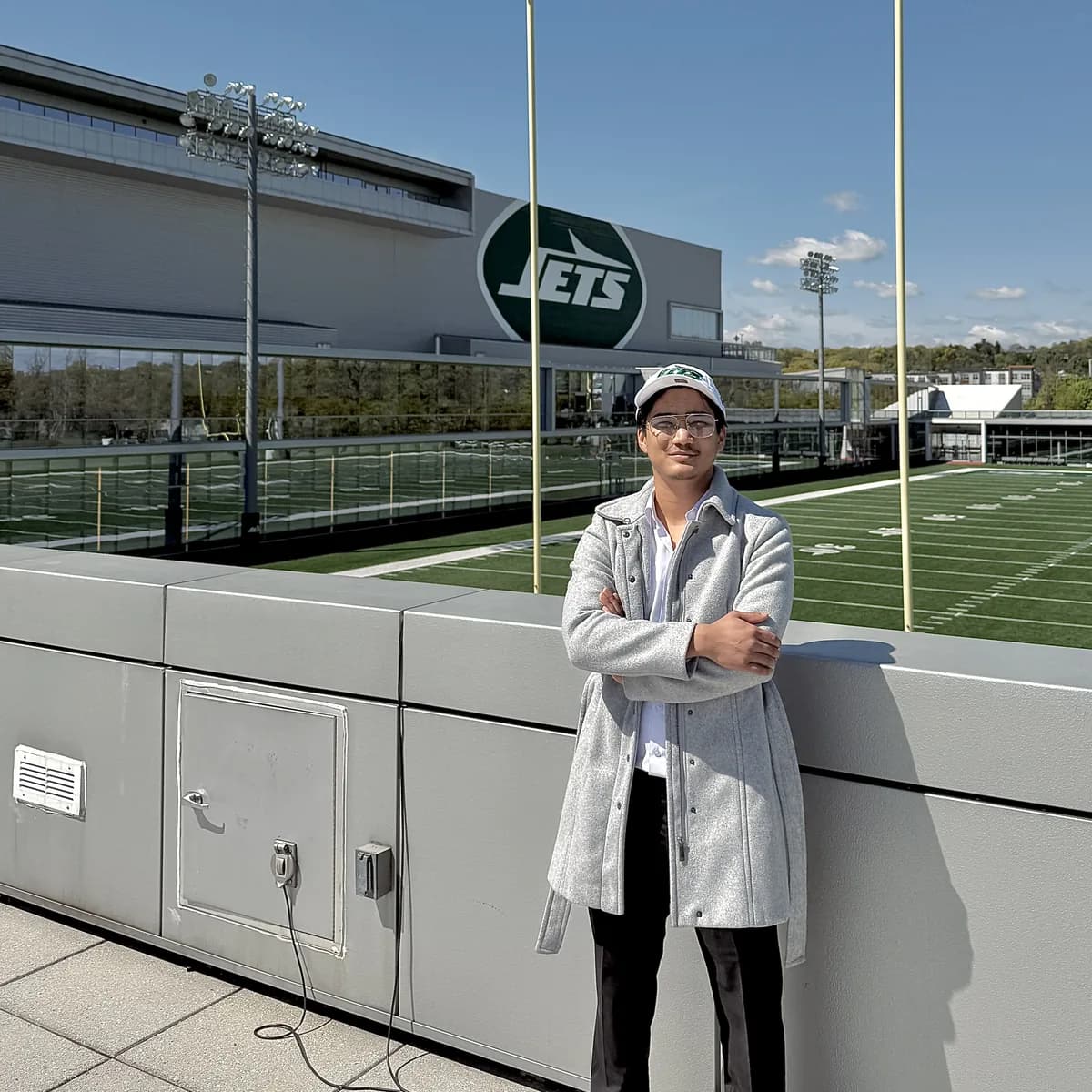 Pratiush on the practice field, the Jets logo on the facility behind him.