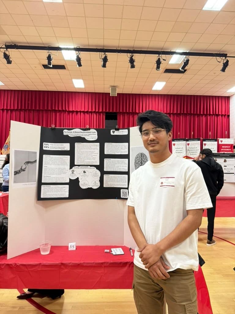 Pratiush standing beside his thesis poster at the symposium.